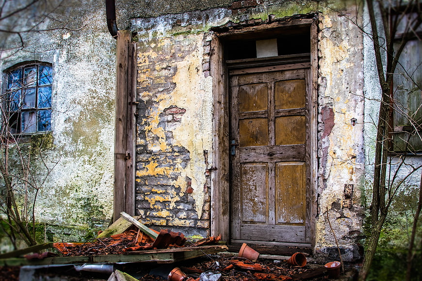 Dilapidated wooden door of an abandoned old building