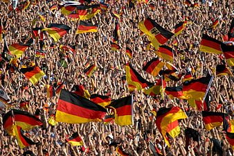 Crowd waving German flags at soccer match