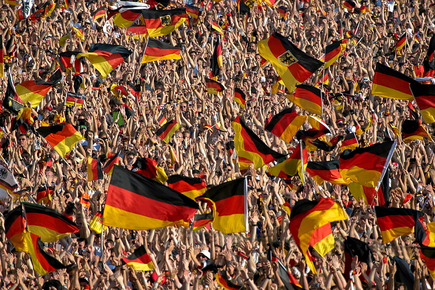 Crowd waving German flags at soccer match