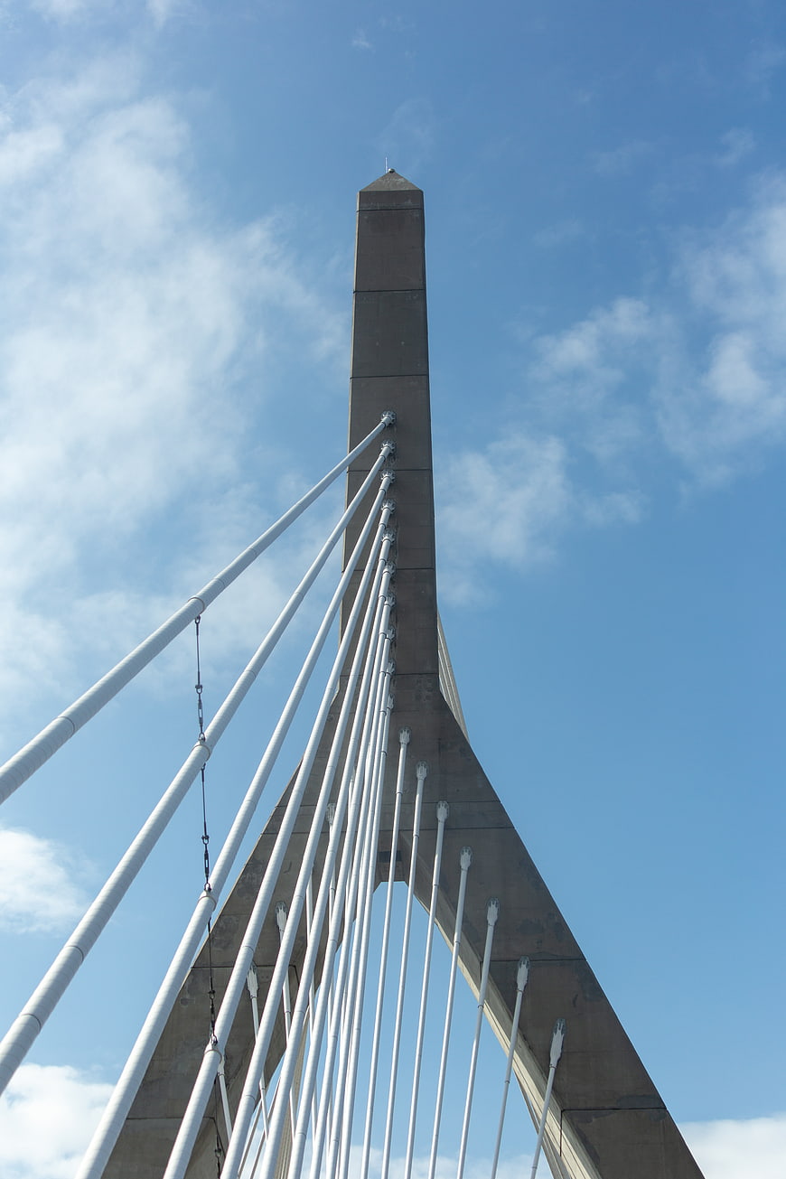 Low angle view of modern cable-stayed bridge tower against blue sky