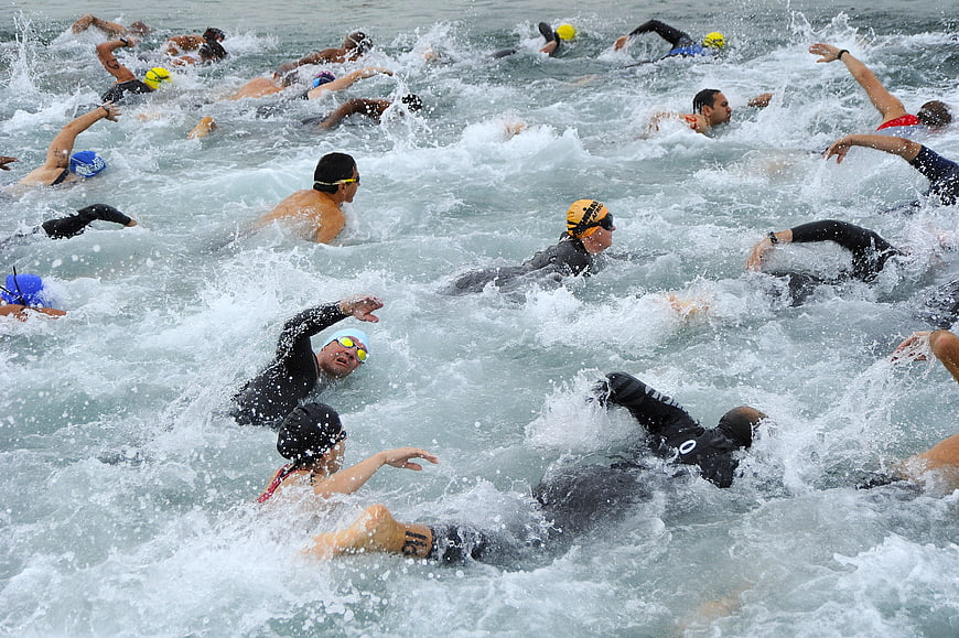 Open Water Triathlon Swimmers Competing in Churning Sea