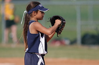 Young Girl Softball Player Preparing to Pitch