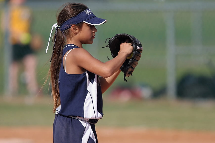 Young Girl Softball Player Preparing to Pitch