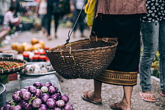 Woman Carrying Woven Basket at Outdoor Vegetable Market