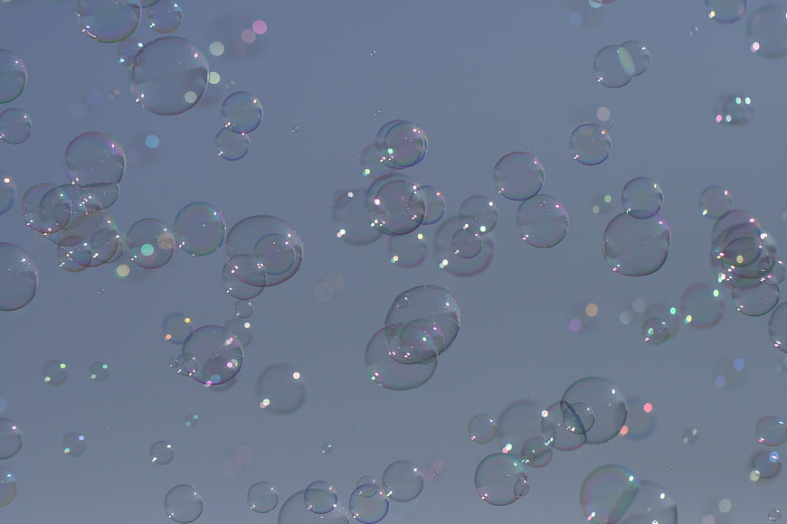 Abstract Soap Bubbles Floating Against Soft Blue Background