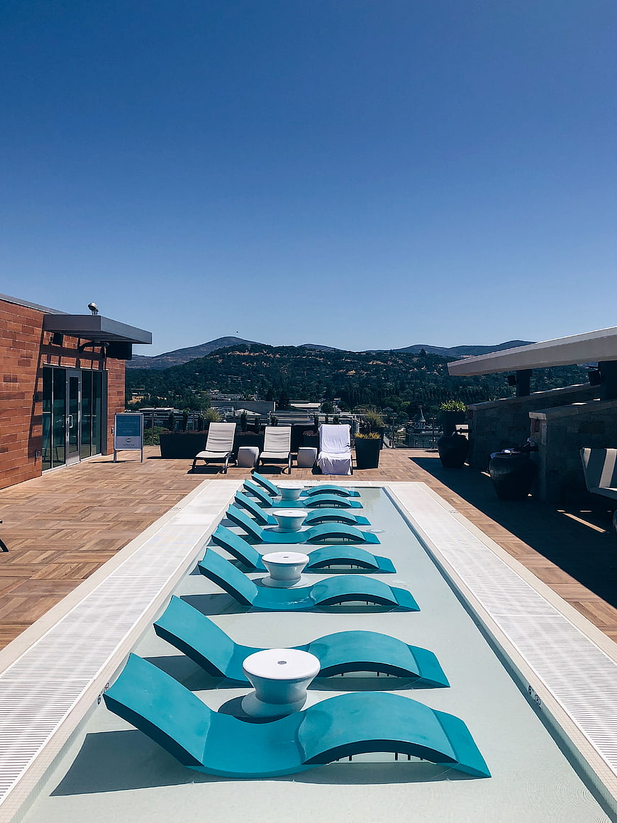 Modern Rooftop Infinity Pool with Turquoise Lounge Chairs