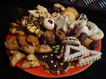 Assorted Christmas Cookies And Pastries On Red Plate