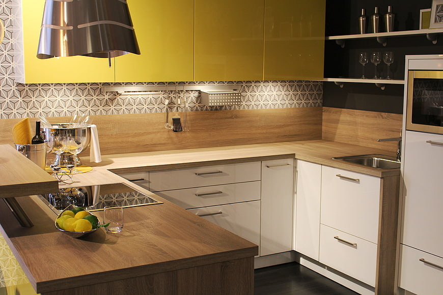 Modern kitchen with yellow cabinets and wooden island