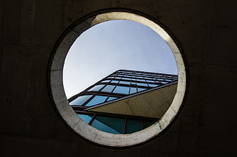 Modern Glass Building Viewed Through Circular Concrete Opening