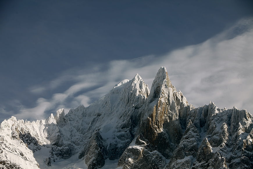 Dramatic Snow-Covered Mountain Peaks with Clouds