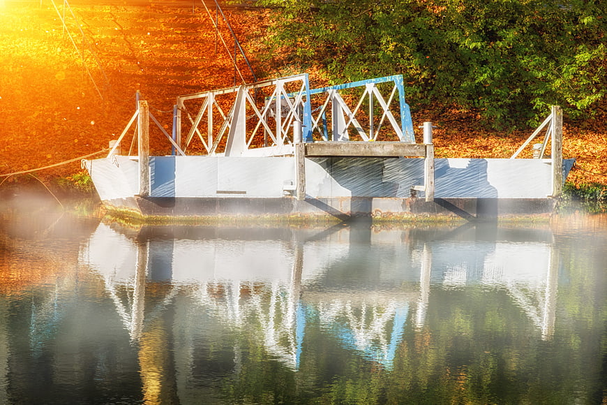 White Barge on Misty River with Autumn Reflections