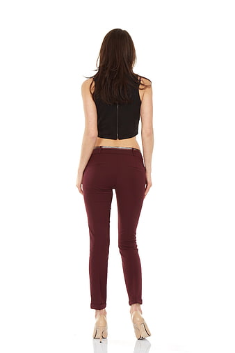 Rear view of woman wearing maroon skinny jeans and black crop top