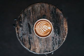 Overhead View of Latte Art on Rustic Wooden Table