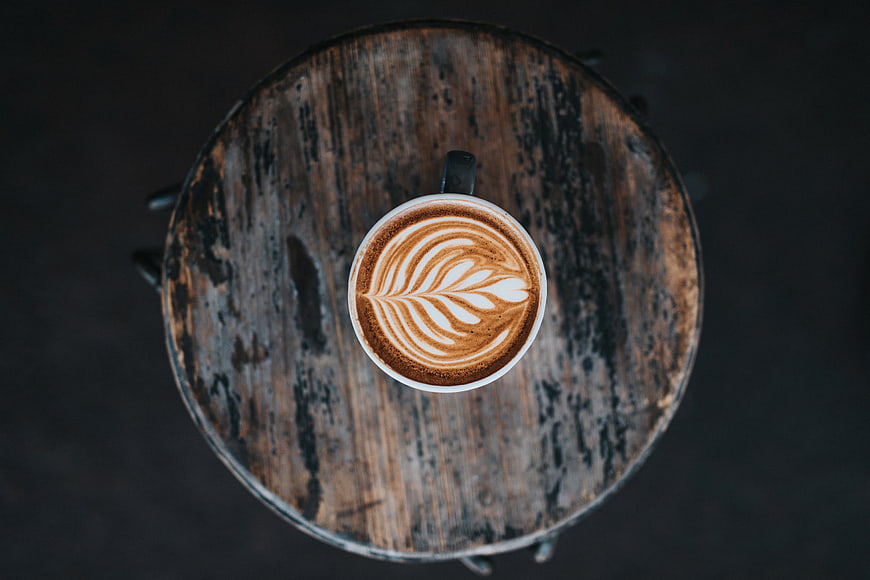 Overhead View of Latte Art on Rustic Wooden Table