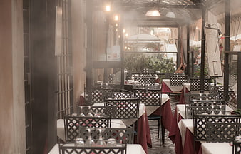 Empty restaurant terrace with set tables and red tablecloths