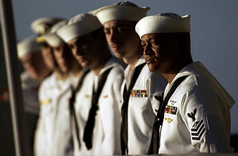 US Navy Sailors In White Uniforms Standing In A Line