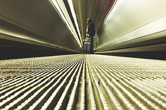 Low Angle Man with Luggage on Escalator