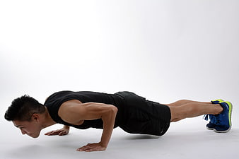 Athletic Man Performing Push-Up Exercise in Studio