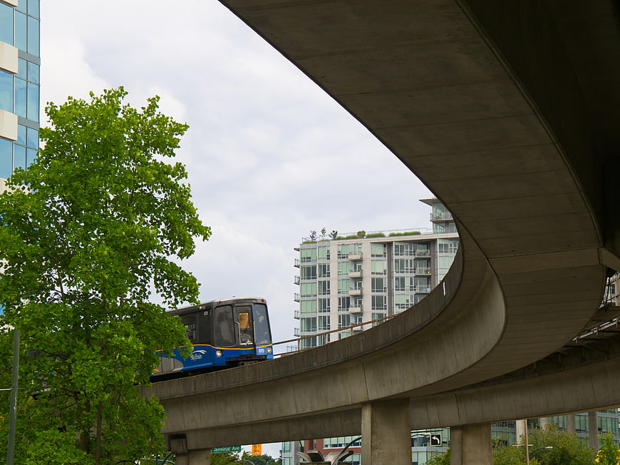Blue SkyTrain on Elevated Track in Vancouver Urban Landscape