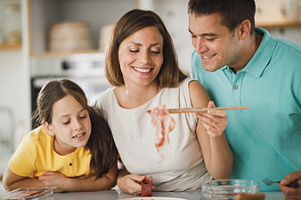 Happy family cooking together in a bright kitchen