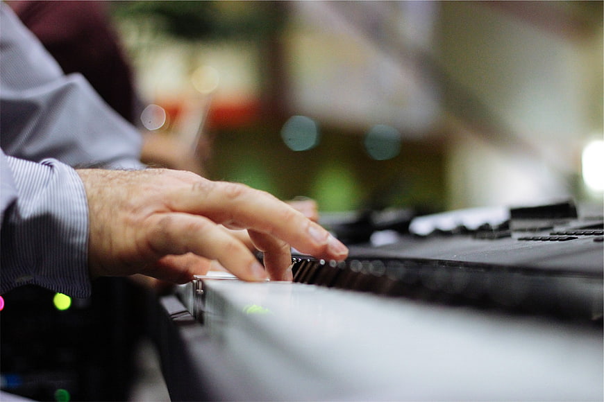 Close-up of hands playing electronic keyboard