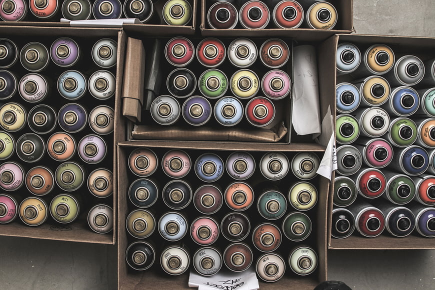 Top View of Organized Spray Paint Cans in Boxes