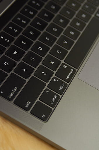 Close-up of laptop keyboard on wooden desk