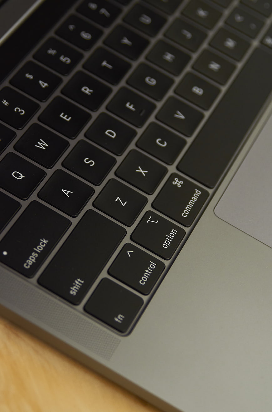 Close-up of laptop keyboard on wooden desk
