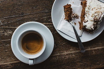 Top view of espresso and carrot cake on rustic wood