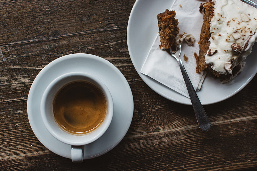 Top view of espresso and carrot cake on rustic wood