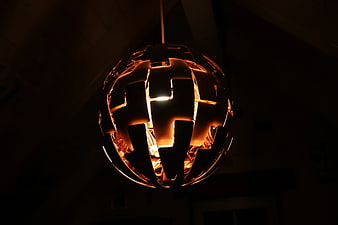 Modern spherical pendant lamp glowing in dark interior