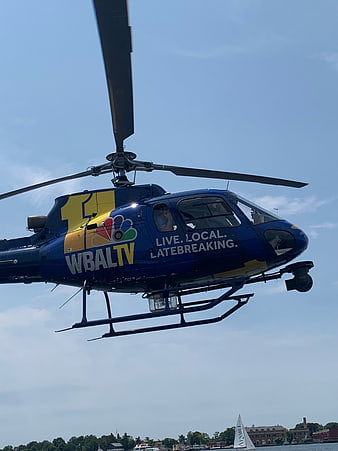 Blue WBALTV News Helicopter Flying Over Water