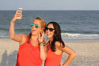 Two Happy Women Taking a Selfie on the Beach
