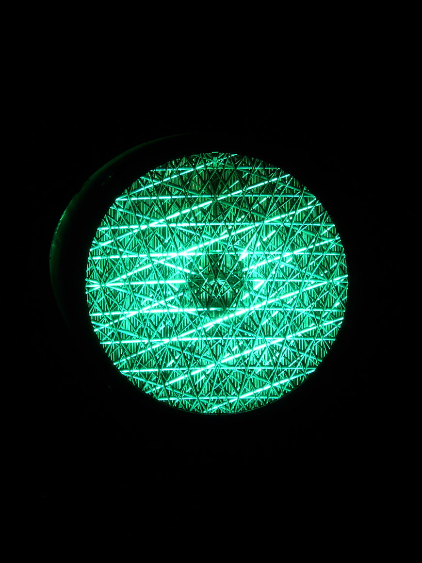 Green Traffic Light Close-Up Detail On Black Background