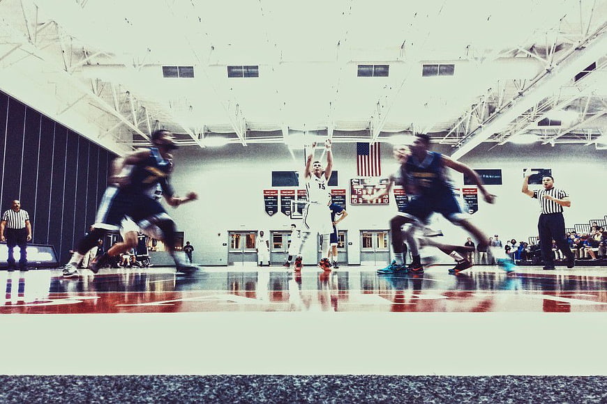 Action Shot of Basketball Players Shooting on Indoor Court