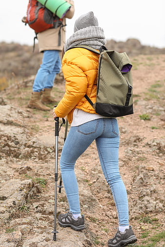Hikers on Rocky Trail with Backpacks and Poles