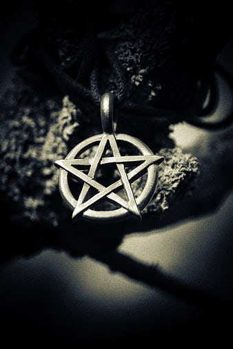 Silver Pentagram Pendant Necklace on Dark Textured Background