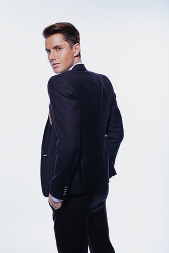 Young Man In Dark Suit Looking Over Shoulder