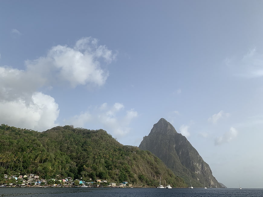 Tropical island landscape with steep mountain and coastal village