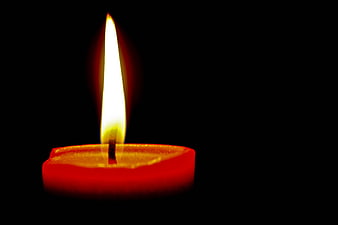Red Candle Burning in Darkness with Bright Flame