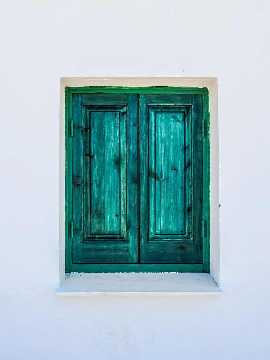 Green Wooden Window Shutters on White Wall