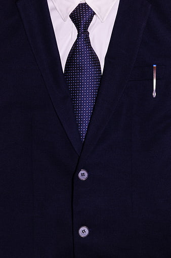Close-up of navy blue business suit with patterned tie