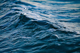 Close-up of deep blue ocean waves with sparkling water surface
