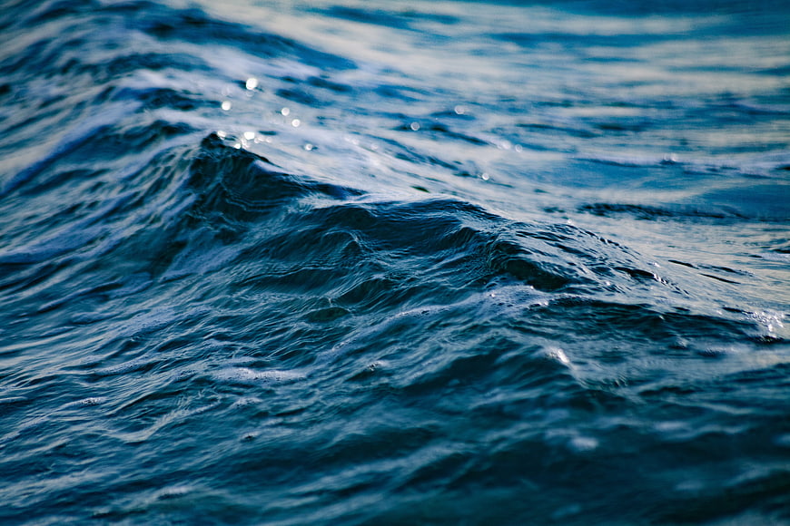 Close-up of deep blue ocean waves with sparkling water surface