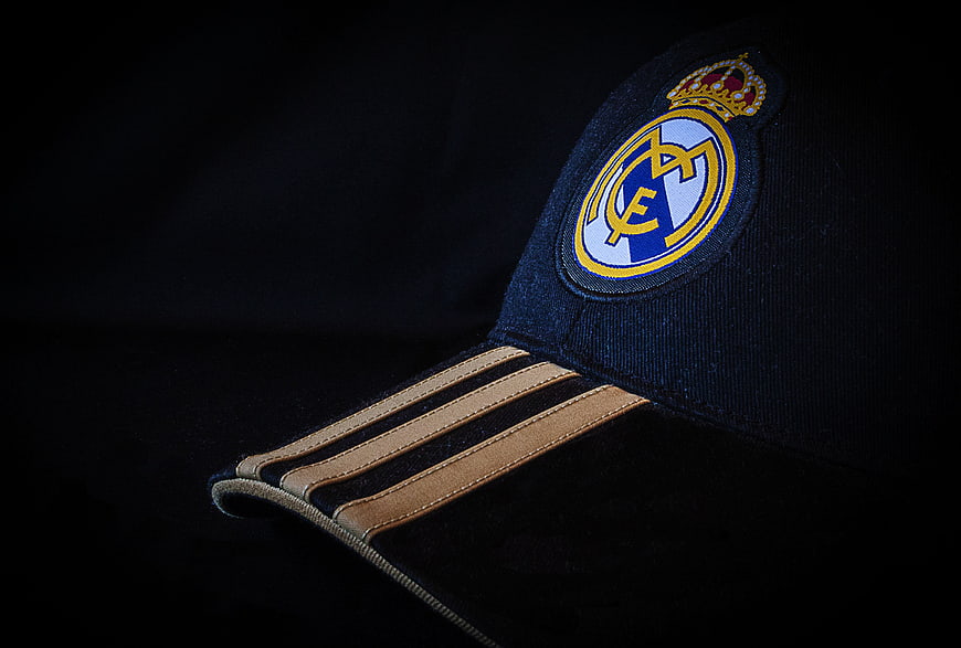 Close-up of a dark blue Real Madrid cap with gold brim stripes