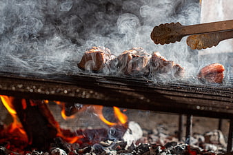 Sizzling Beef Steaks Grilling Over Charcoal Fire