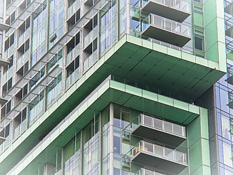 Modern Green Glass Apartment Building Facade with Balconies