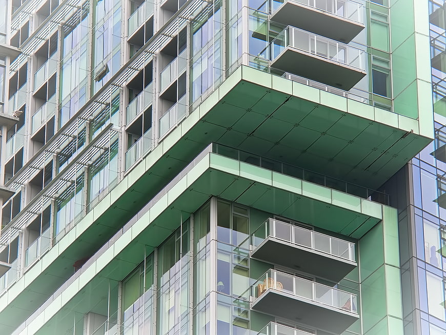 Modern Green Glass Apartment Building Facade with Balconies