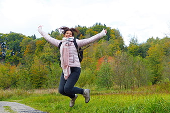 Happy Woman Jumping in Autumn Forest Meadow