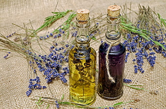 Lavender essential oil bottles on burlap background